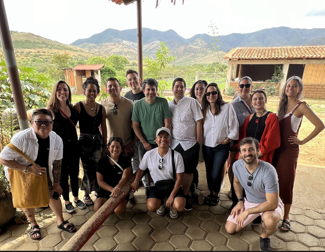 CookUnity team members gathered together at a retreat with mountains in the background